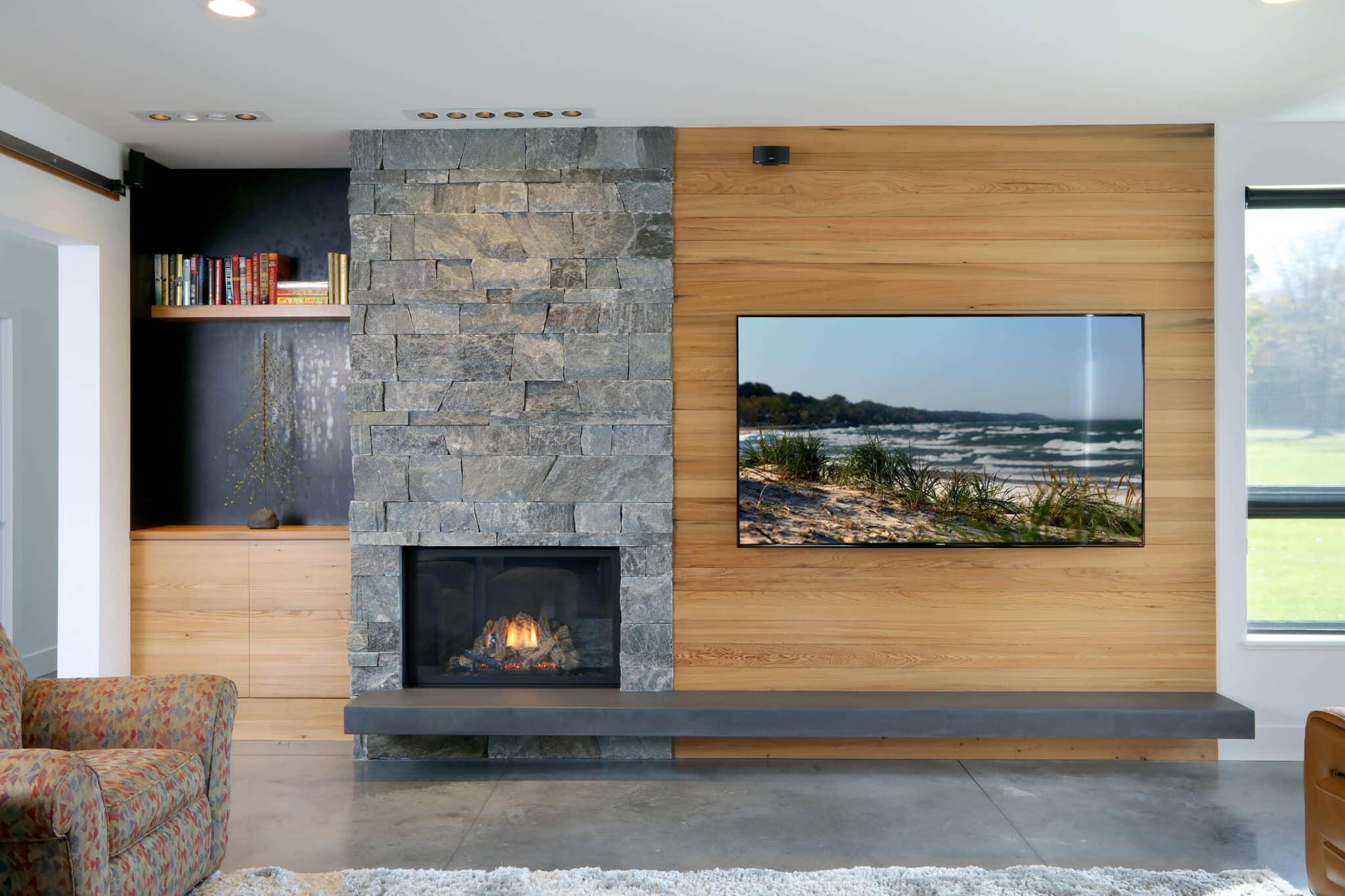 Double-sink concrete vanity with wood cabinetry.